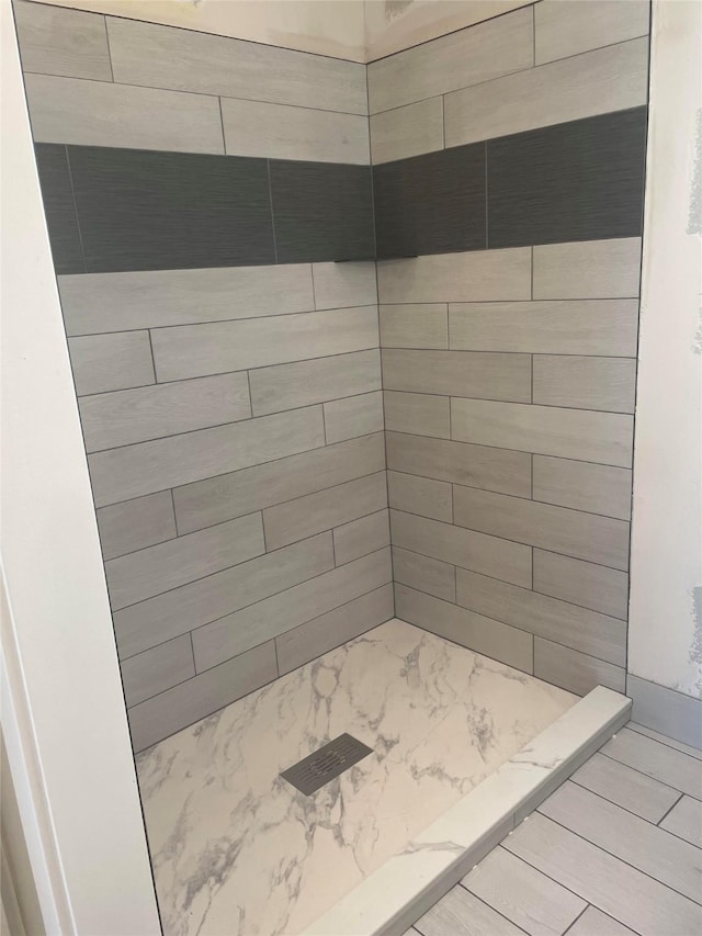 full bathroom with a tile shower