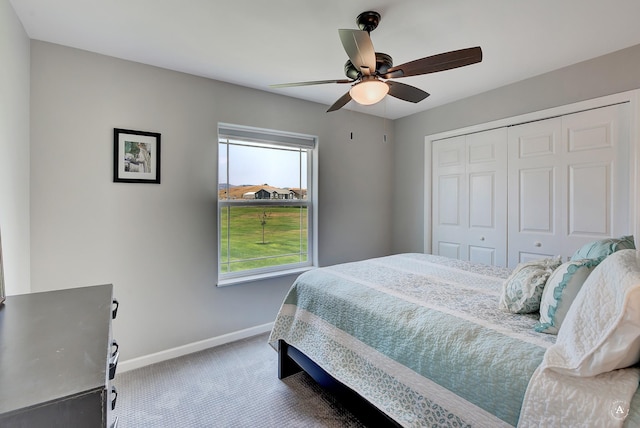 carpeted bedroom with a ceiling fan, baseboards, and a closet