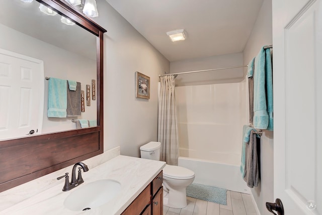 bathroom with vanity, shower / tub combo, and toilet