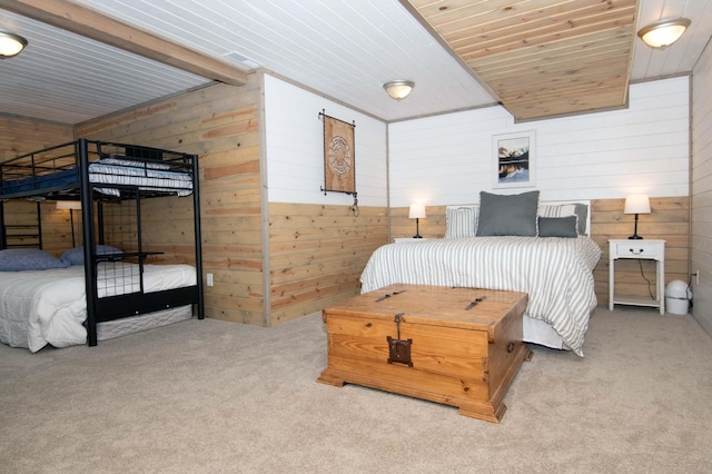 bedroom featuring carpet, wood walls, and wooden ceiling