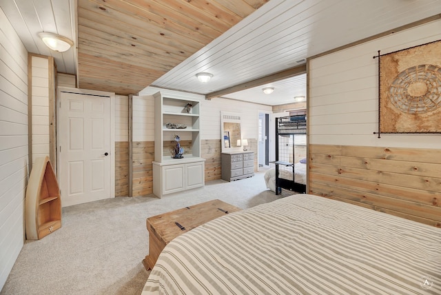 carpeted bedroom featuring wooden ceiling and wooden walls