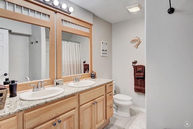 bathroom featuring a sink, toilet, double vanity, and tile patterned floors