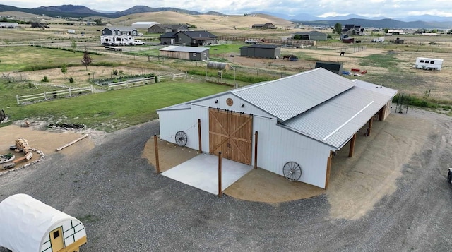 drone / aerial view with a mountain view and a rural view