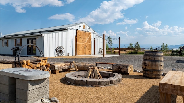 view of yard featuring a fire pit and an outdoor structure