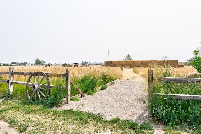 view of yard with a rural view and fence