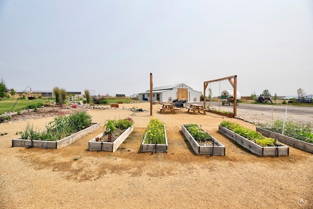 view of jungle gym featuring a vegetable garden