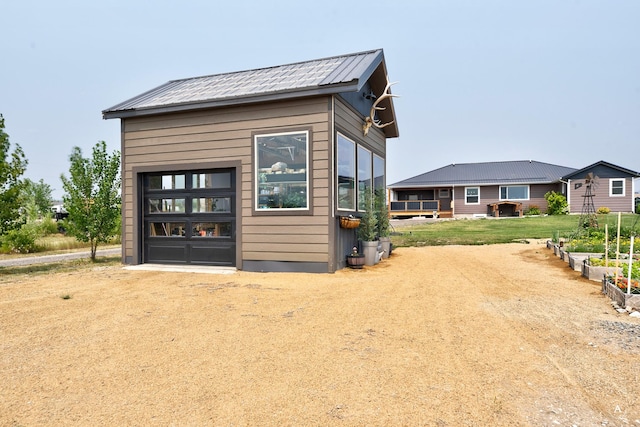 view of outbuilding with a garage and dirt driveway