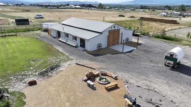 drone / aerial view featuring a mountain view and a rural view