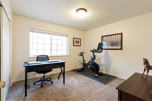 carpeted office space featuring baseboards