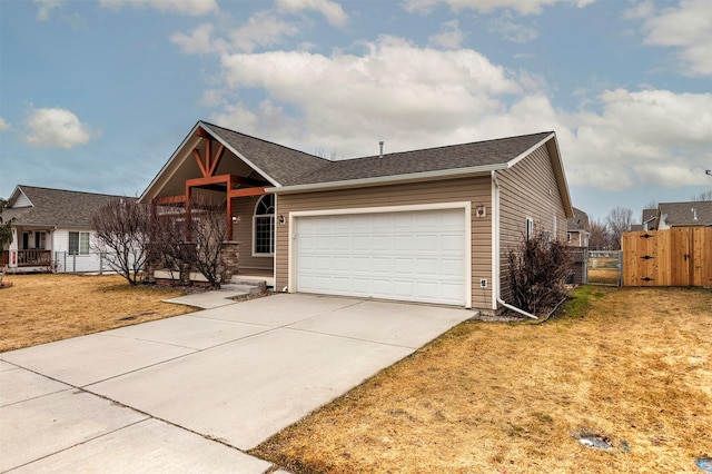 ranch-style house featuring concrete driveway, a gate, fence, and a garage