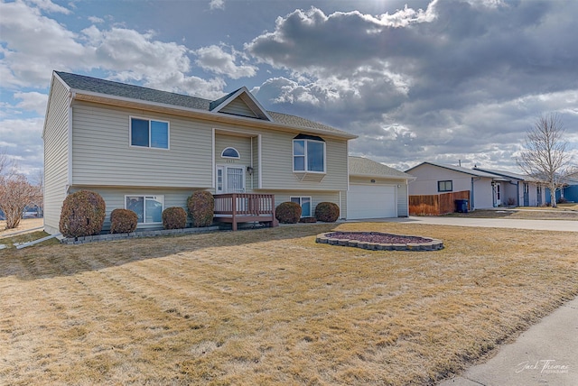 bi-level home with driveway and a front yard