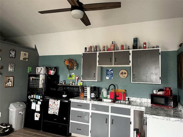 kitchen featuring gray cabinets, a sink, black electric range, wood finished floors, and light countertops