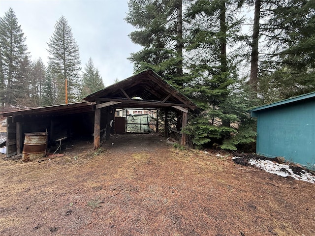 exterior space featuring a carport and an outdoor structure