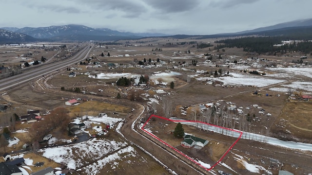 snowy aerial view featuring a mountain view