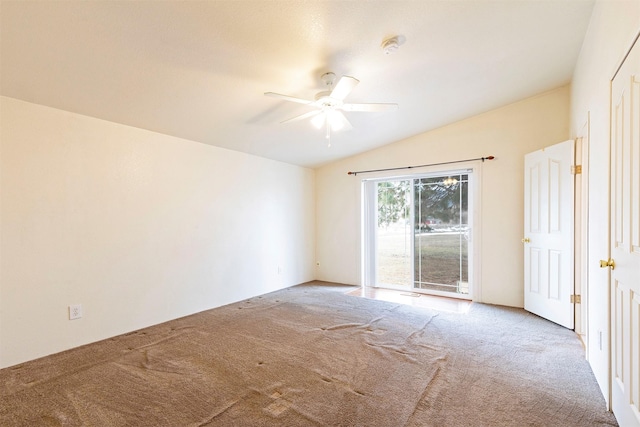 carpeted empty room featuring a ceiling fan and lofted ceiling