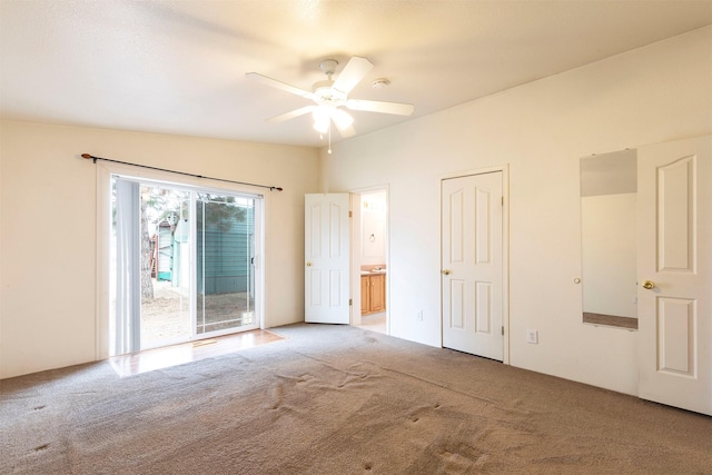 spare room featuring carpet flooring and a ceiling fan