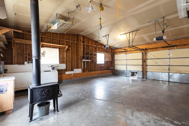 garage featuring a wood stove and a garage door opener