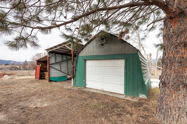 detached garage with dirt driveway