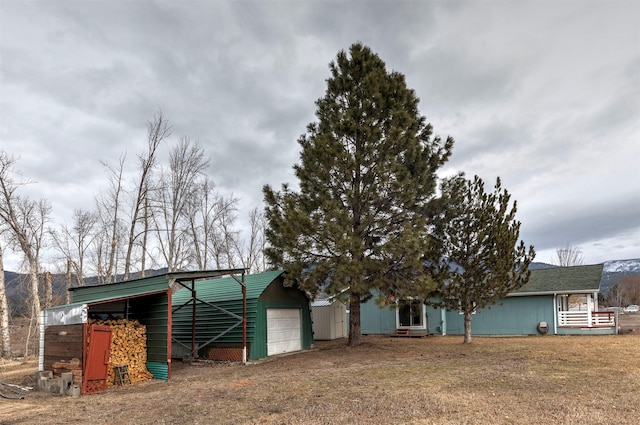 view of outbuilding featuring a garage and an outbuilding