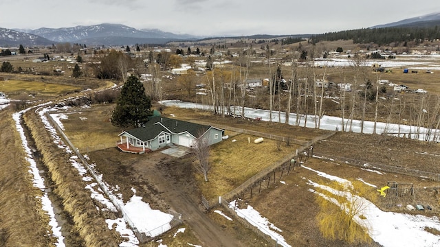 snowy aerial view with a rural view and a mountain view