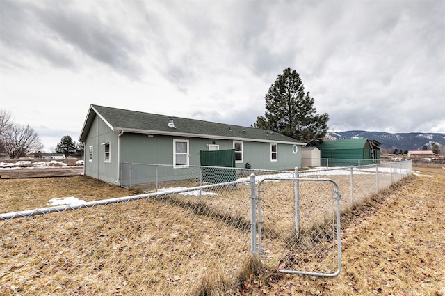 back of property featuring fence