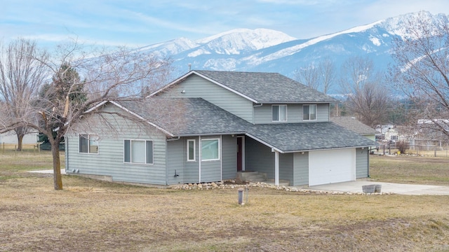 traditional-style home with a mountain view, roof with shingles, and a front yard