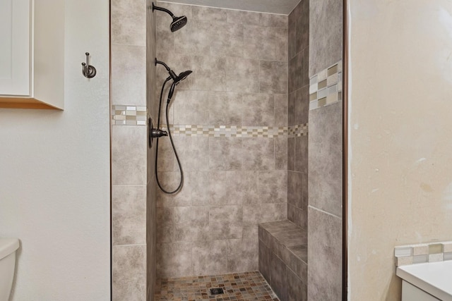 full bath featuring toilet and tiled shower