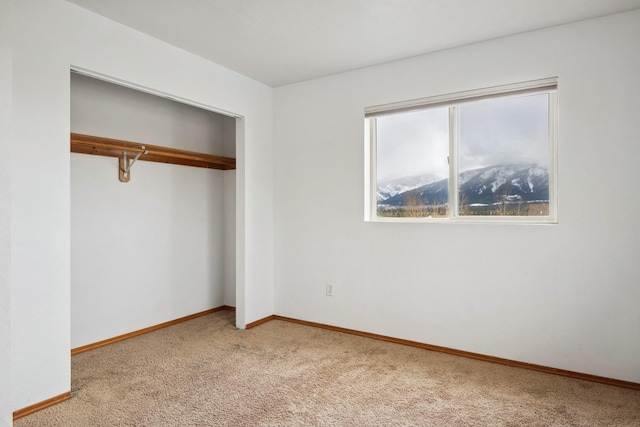 unfurnished bedroom with a closet, baseboards, and carpet