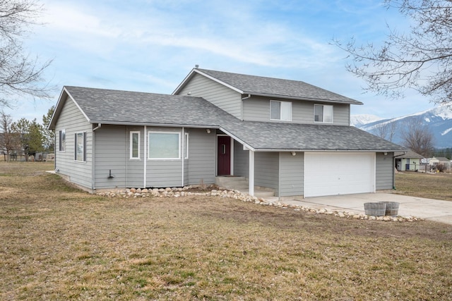 split level home with an attached garage, driveway, a front lawn, and roof with shingles