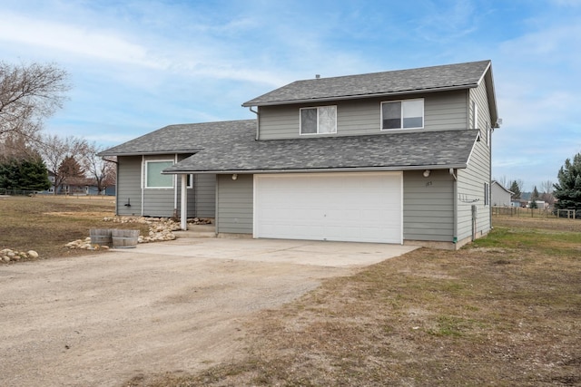 view of front of property with a garage, fence, driveway, and a shingled roof