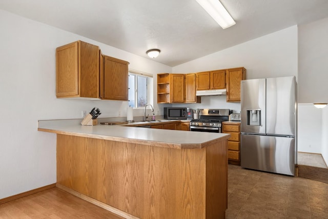 kitchen with a peninsula, open shelves, a sink, stainless steel appliances, and vaulted ceiling