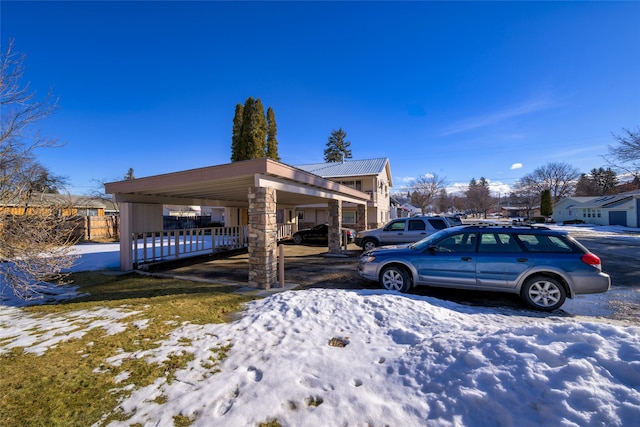 view of snowy exterior with fence