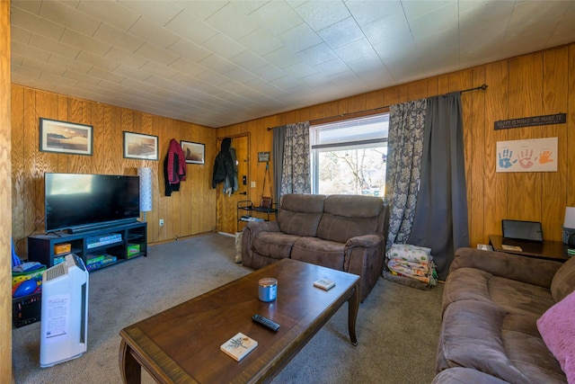 living room featuring carpet and wood walls