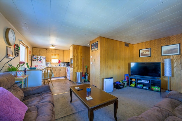 living room with wooden walls and carpet