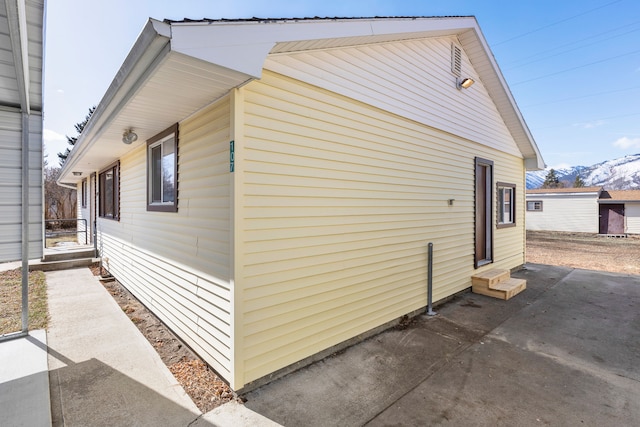 view of side of home with entry steps