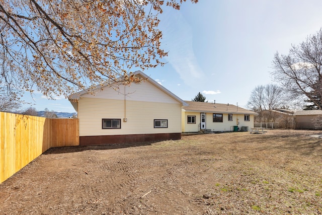 back of house with a fenced backyard