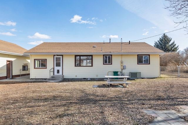 back of house with entry steps, central air condition unit, and fence