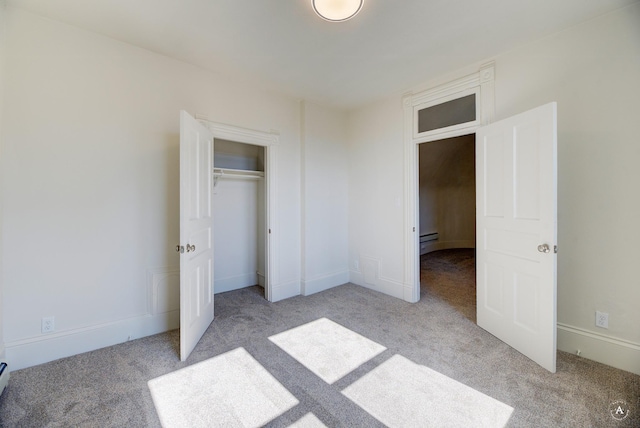 unfurnished bedroom featuring a closet, baseboards, and carpet