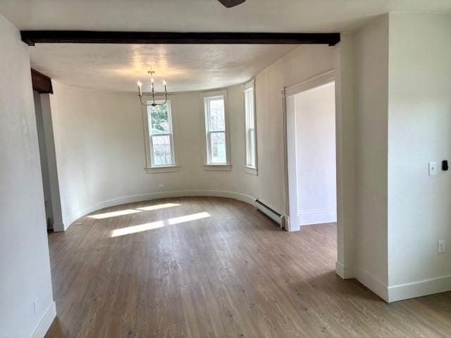 unfurnished room with a baseboard radiator, baseboards, beamed ceiling, and wood finished floors