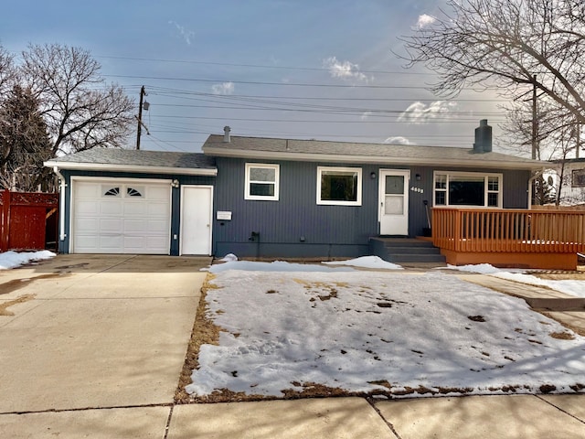 view of front of property featuring driveway, a chimney, and a garage