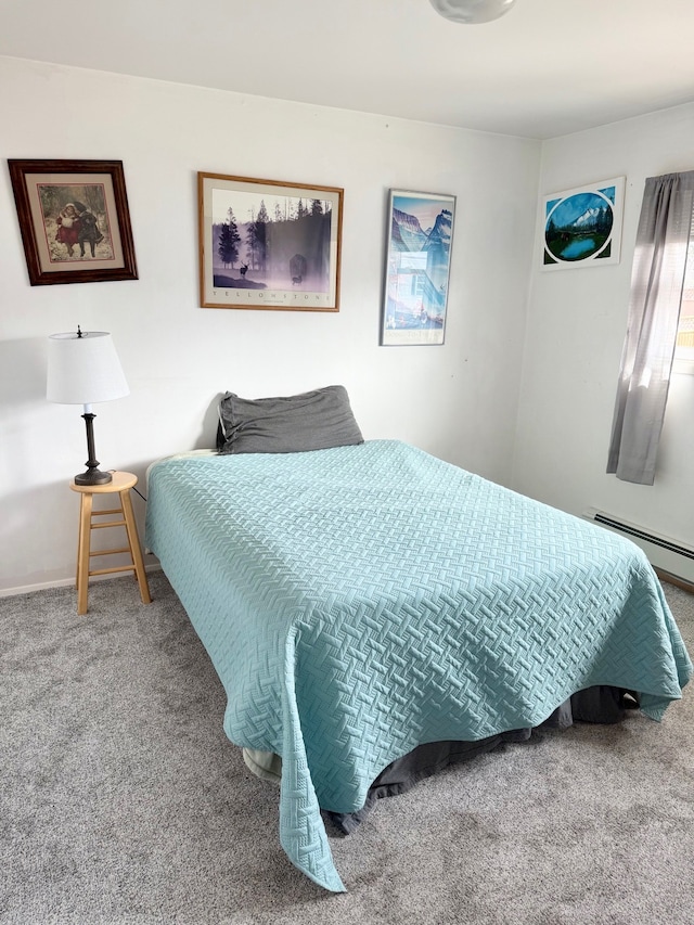 carpeted bedroom featuring baseboard heating and baseboards