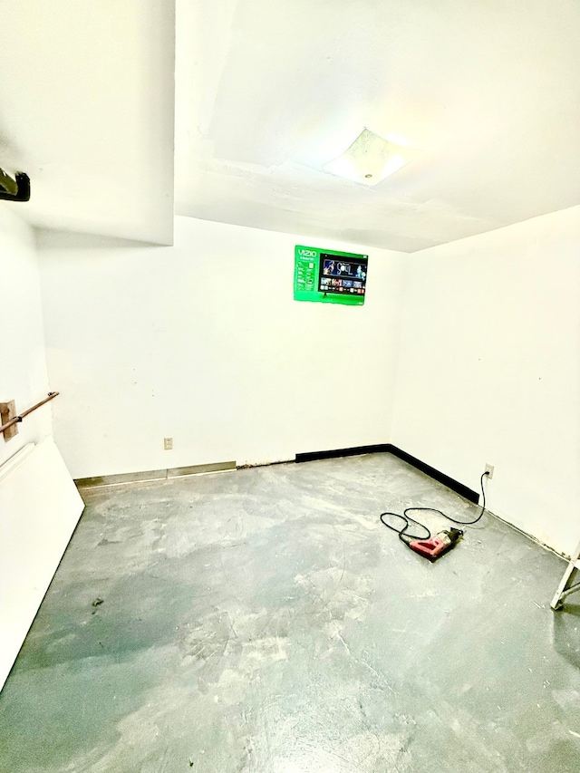 unfurnished room featuring concrete flooring