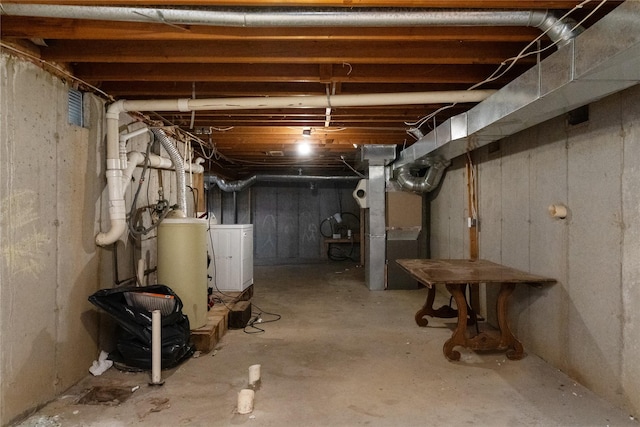 unfinished basement featuring heating unit and separate washer and dryer