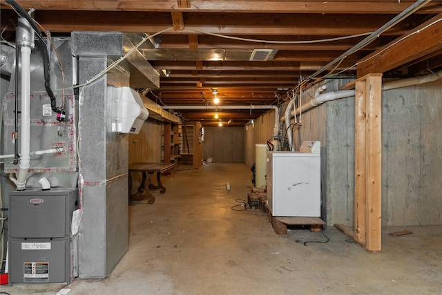 unfinished basement with heating unit and washer / clothes dryer