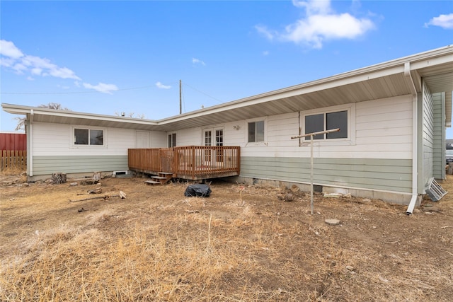 rear view of property featuring a deck