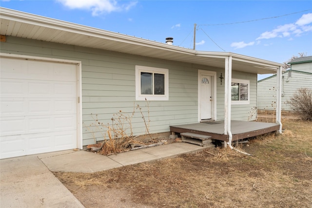 entrance to property with an attached garage and covered porch