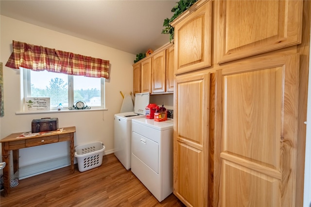 washroom with cabinet space, light wood-style flooring, and separate washer and dryer