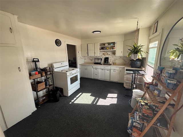 kitchen featuring white range, open shelves, tasteful backsplash, white cabinets, and light countertops