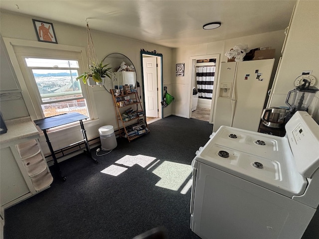 washroom featuring washer / dryer, a baseboard heating unit, and baseboards