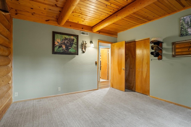 32 Peaceful Ct, Bigfork, MT 59911 - unfurnished bedroom featuring a wooden ceiling with exposed beams, carpet floors, and rustic walls